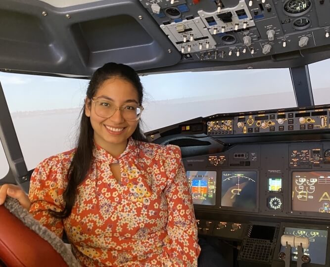 Harvard SEAS student Roaa Marei, S.B. '25, inside an aircraft cockpit