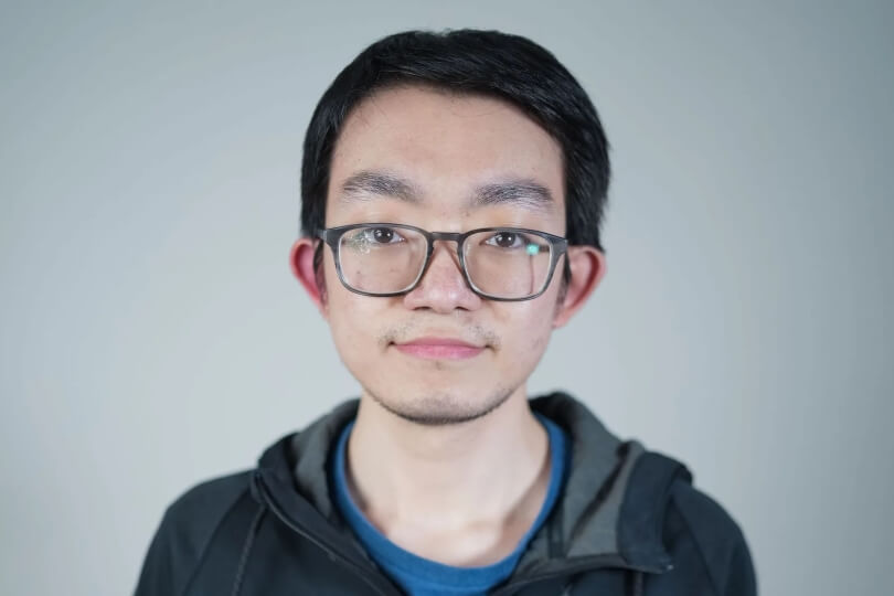 A male Harvard SEAS student wearing glasses